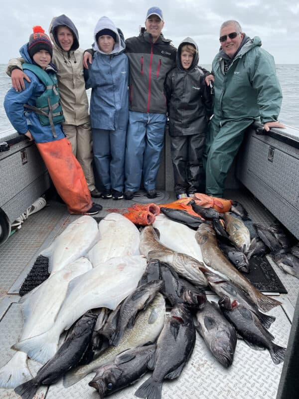 men on boat with fish
