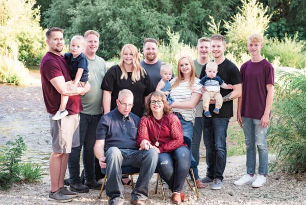 large family in family portrait by river