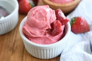 homemade strawberry frozen yogurt in white cup with silver spoon
