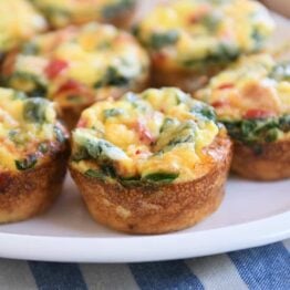 five hash brown veggie egg cups on white platter