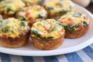 five hash brown veggie egg cups on white platter