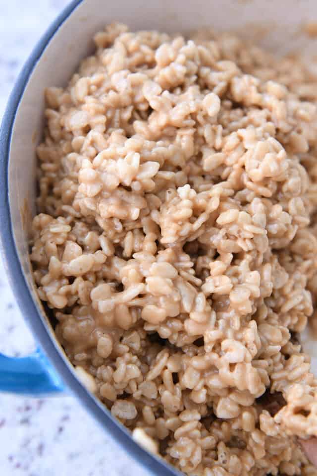 Blue cast iron pan with rice krispie peanut butter mixture.