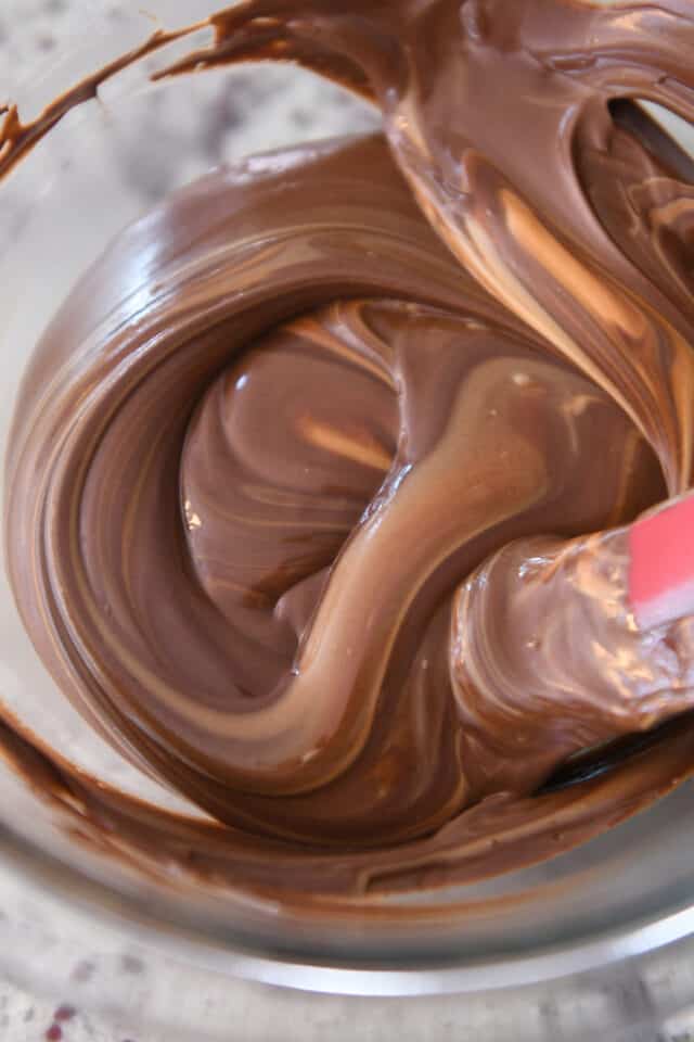 Melted chocolate chips and butterscotch chips in glass bowl.