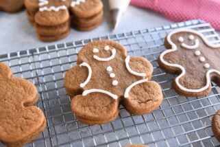 several decorated gingerbread people cookies on wire rack