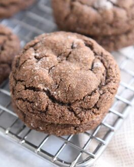 two chocolate ginger molasses cookies stacked on cooling rack