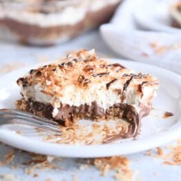 piece of samoas chocolate pudding dessert on white plate with bite taken out