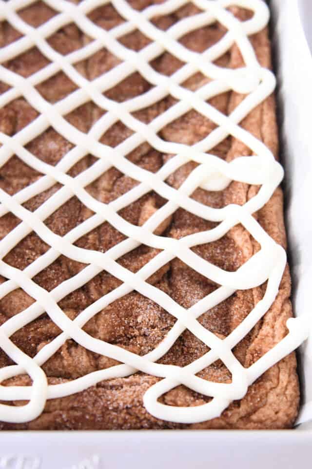 Iced cinnamon roll blondie bars in 9X13-inch metal pan.