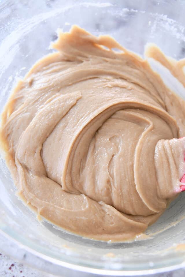 Cinnamon roll blondie cookie batter in glass bowl.