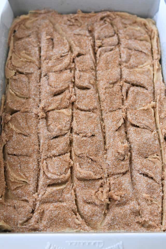 Cinnamon and sugar swirled in top of cookie batter in metal 9X13-inch pan.