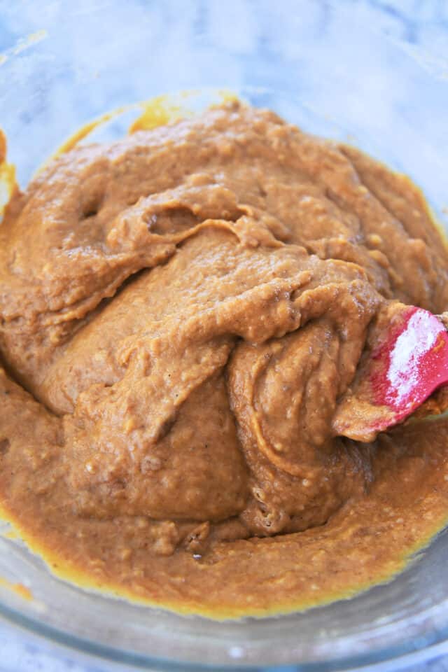 Pumpkin muffin batter in glass bowl.