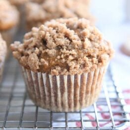 Pumpkin snickerdoodle muffin on cooling rack.