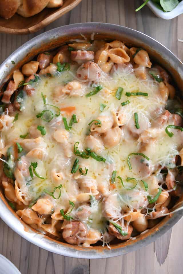 Top down view of cheese baked on top of pasta shells.