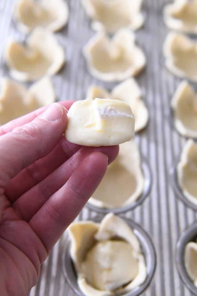 Piece of brie cheese pressed into disc.