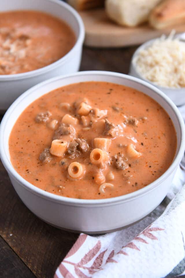 Bowl of tomato soup with noodles and ground beef.