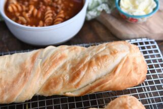 Loaf of twisted croissant French bread on cooling rack.