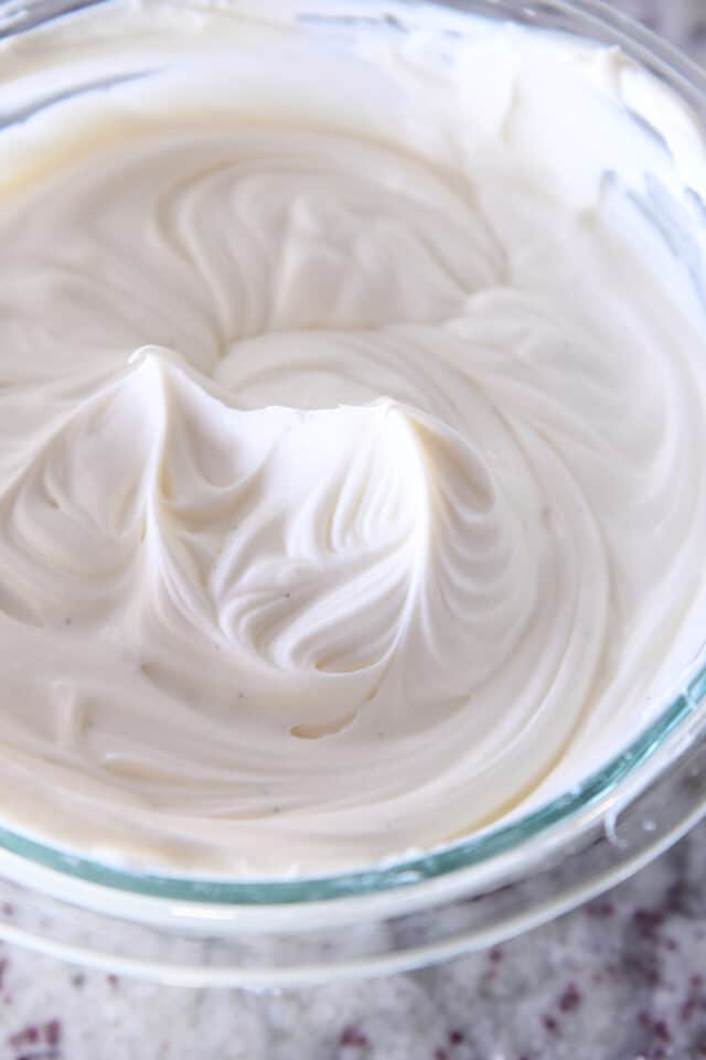Whipped white chocolate mousse in glass bowl.