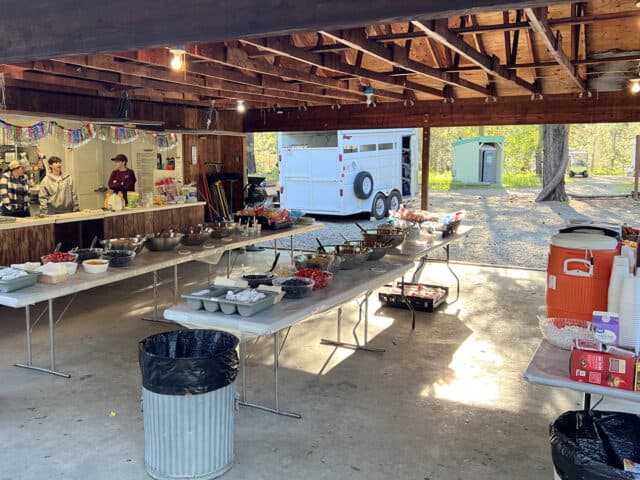 Tables set up outside with food for breakfast.