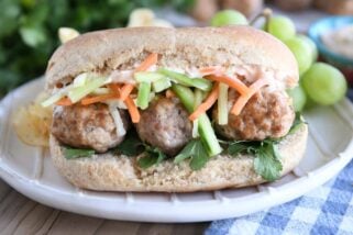 Banh mi meatball sub on cream plate.