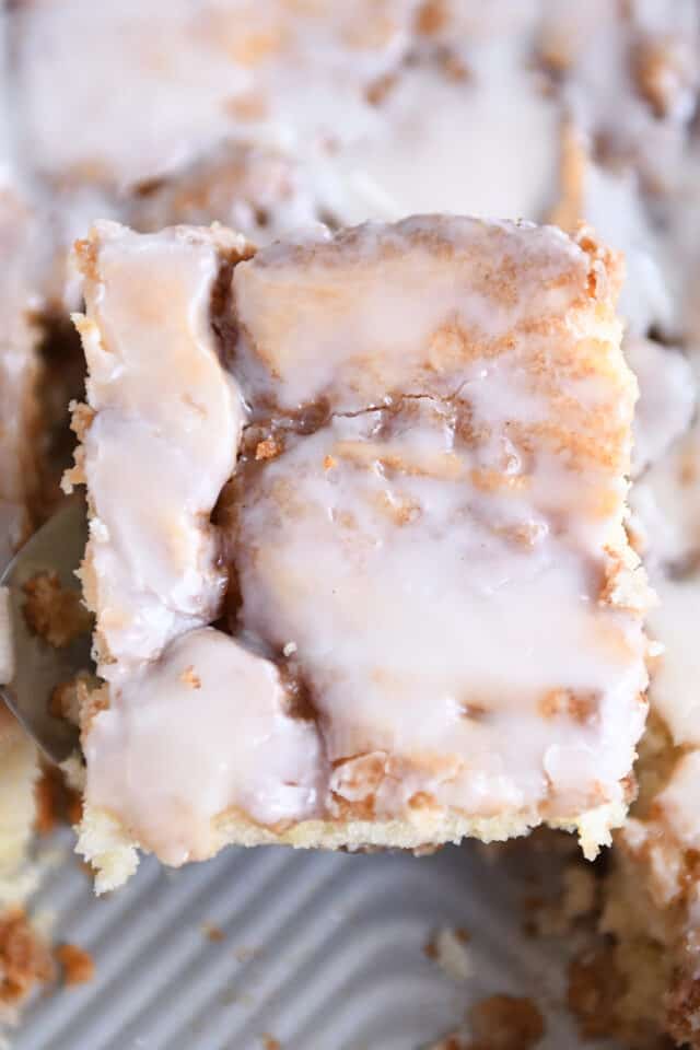 Piece of cinnamon roll cake on spatula.