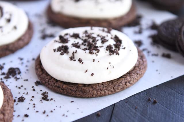 Chocolate cookie with white frosting and Oreo cookie crumbs.