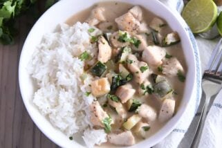 Top down view of chicken and zucchini in cream sauce over white rice.