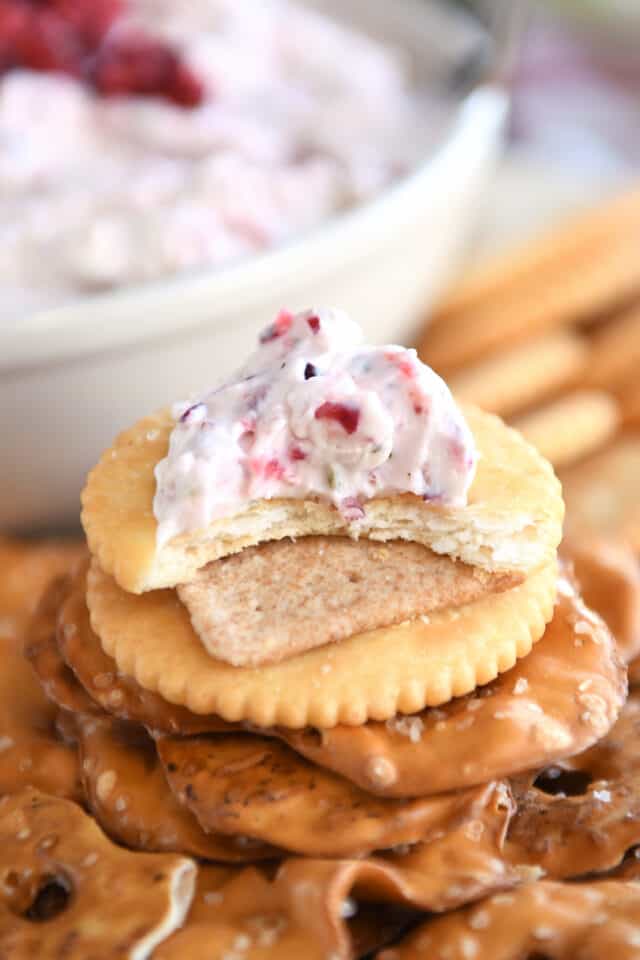 Ritz cracker with dollop of cranberry jalapeno dip with bite taken out.