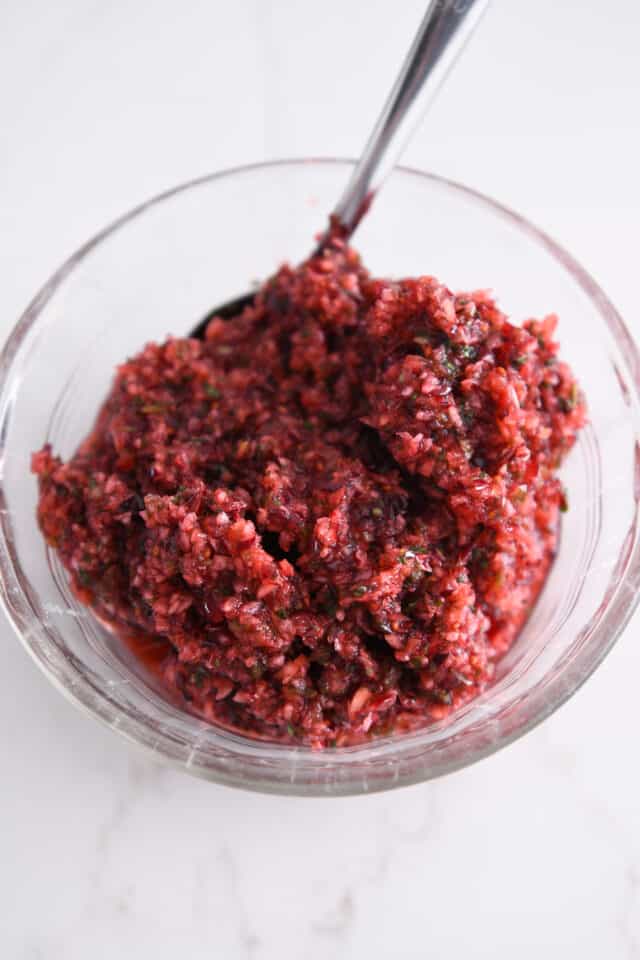 Glass bowl with fresh cranberry jalapeno relish.