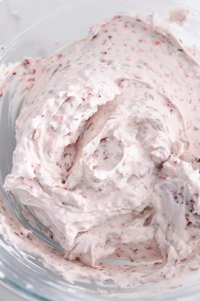 Glass bowl with mixed cream cheese and cranberry jalapeno relish.