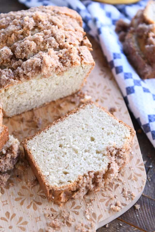 Slice of cream cheese banana bread on cutting board.