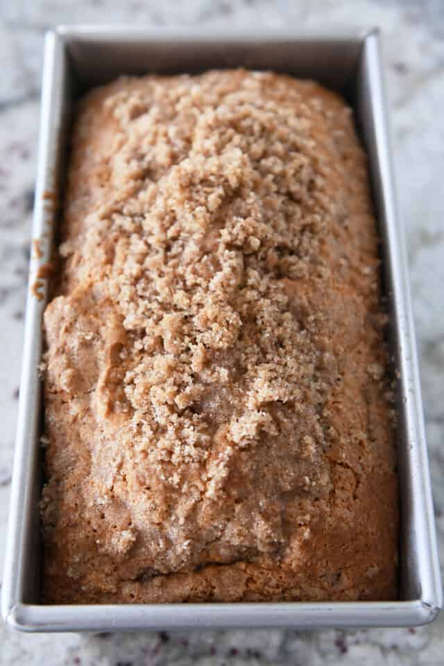 Baked loaf of cream cheese banana bread in bread pan.