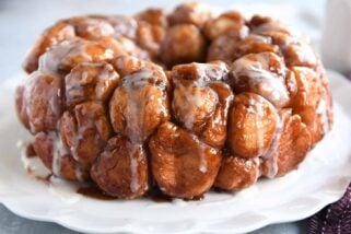 Monkey bread turned out onto white tray and glazed.