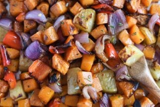 Roasted potatoes, red onions, red bell peppers and butternut squash on sheet pan.