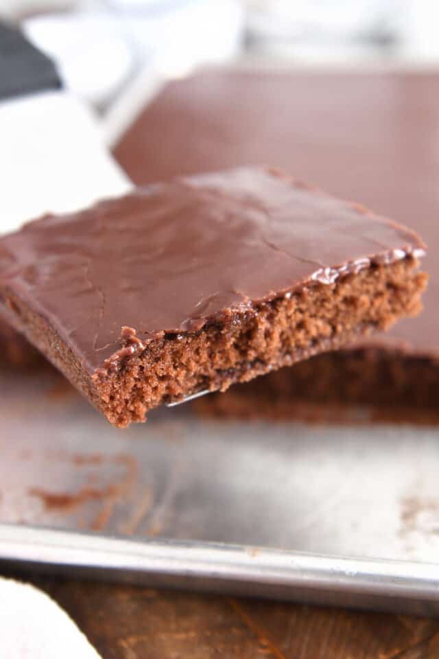 Square of Texas sheet cake on spatula.