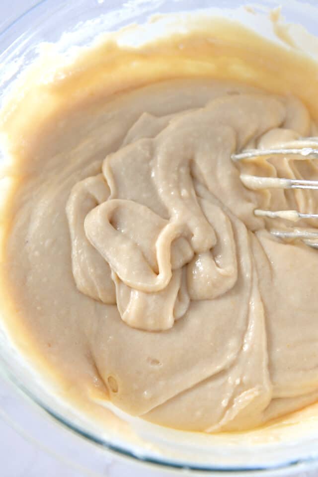 Glass bowl with vanilla muffin batter.