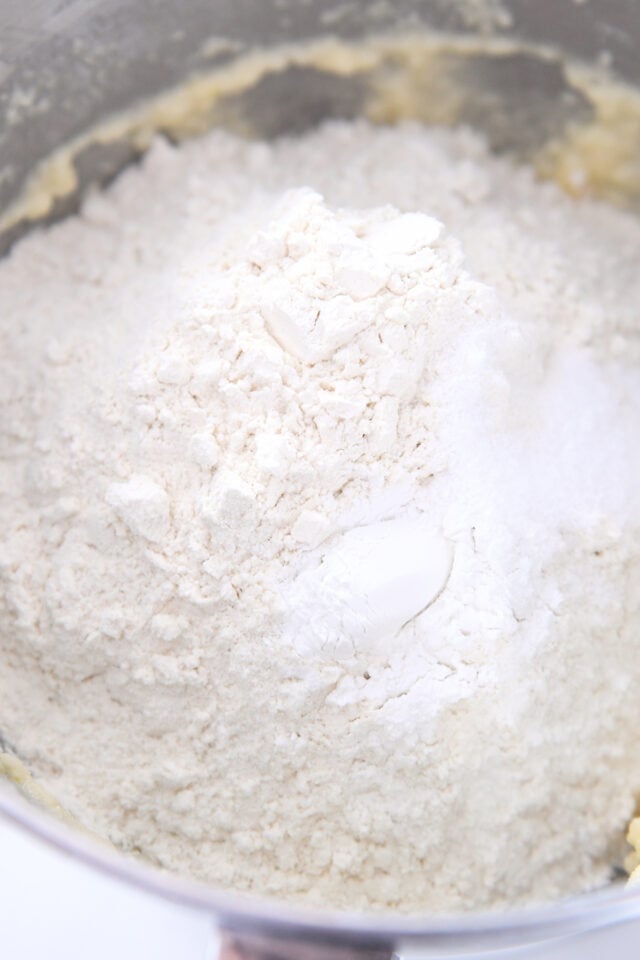 Flour, baking powder and butter in stainless bowl.