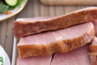 Ham slices on white platter.