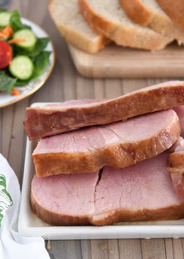 Ham slices on white platter.
