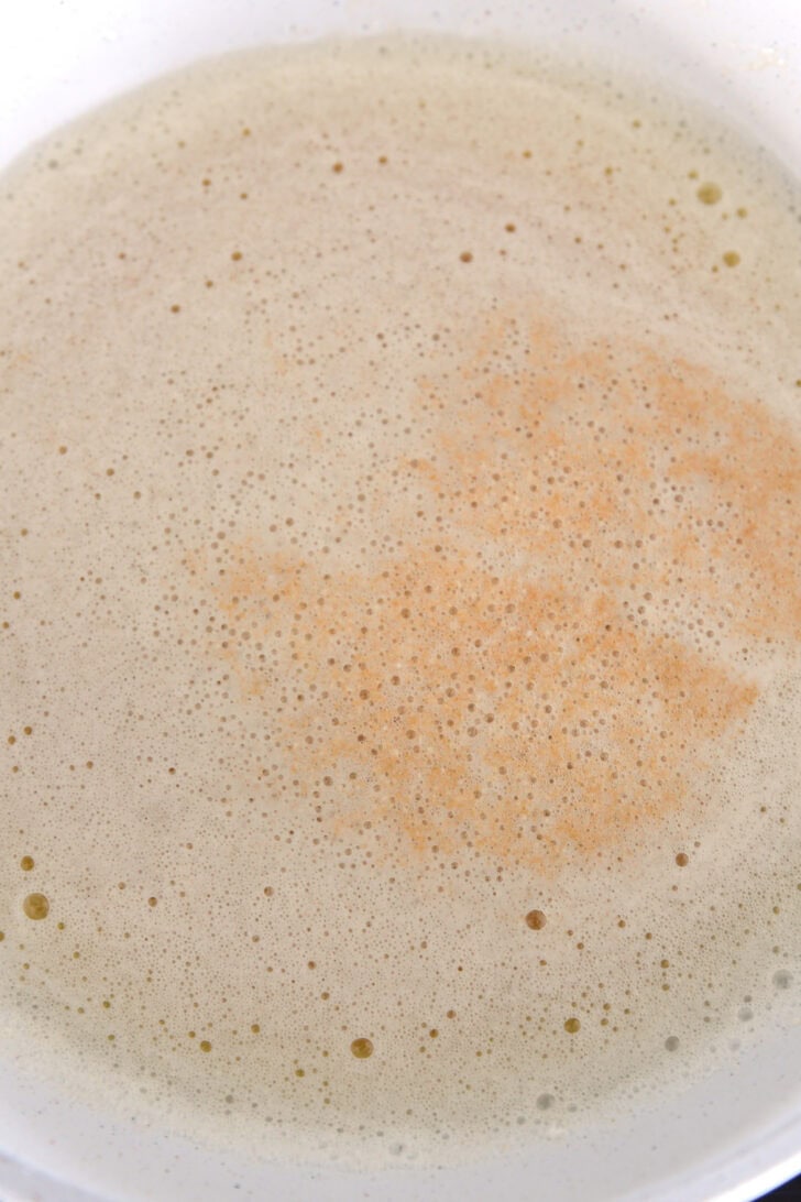 Browning butter in white skillet.