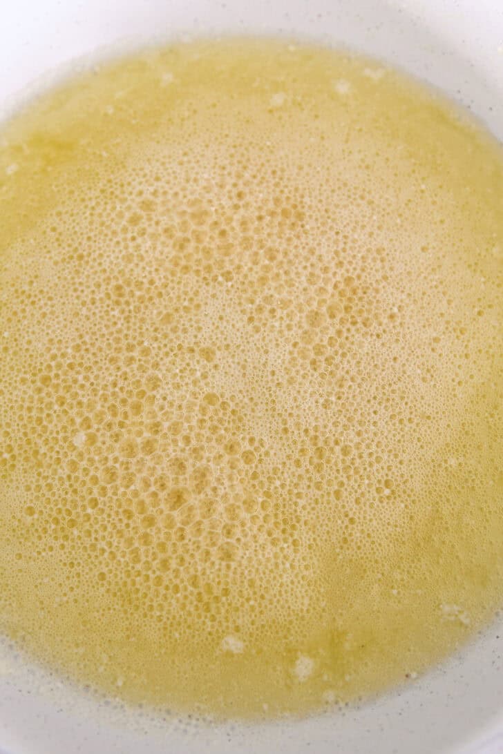 Browning butter in white skillet.