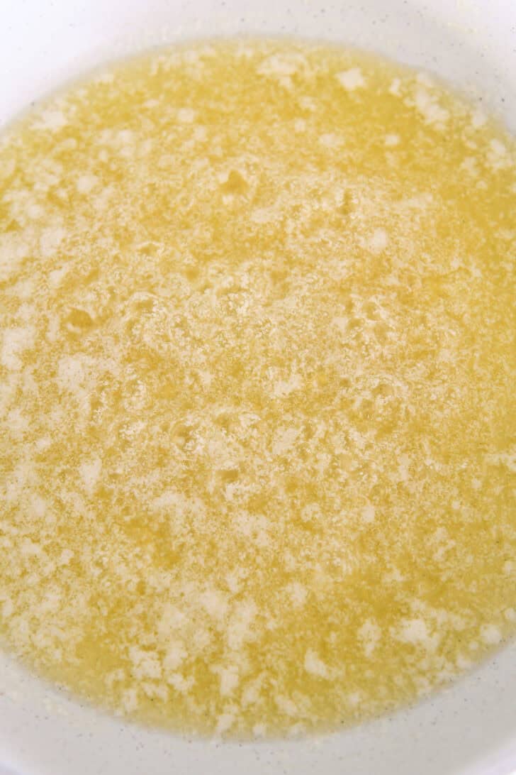 Browning butter in white skillet.