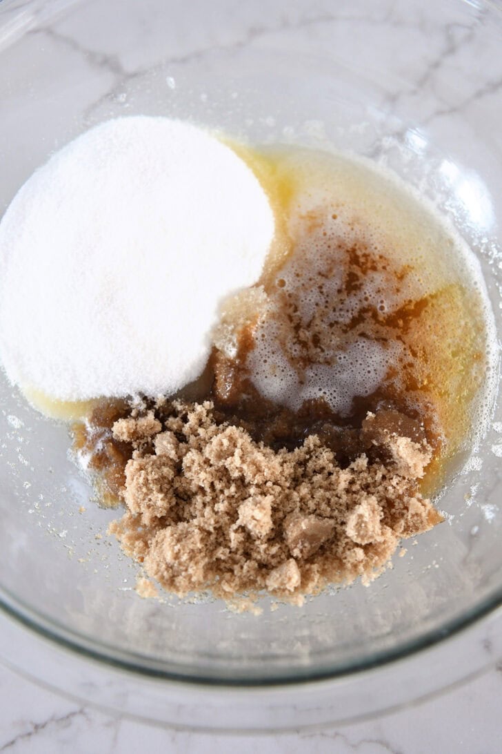 Sugar, brown butter, brown sugar in glass bowl.