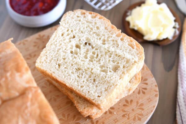 Slice of English muffin bread on wood cutting board.