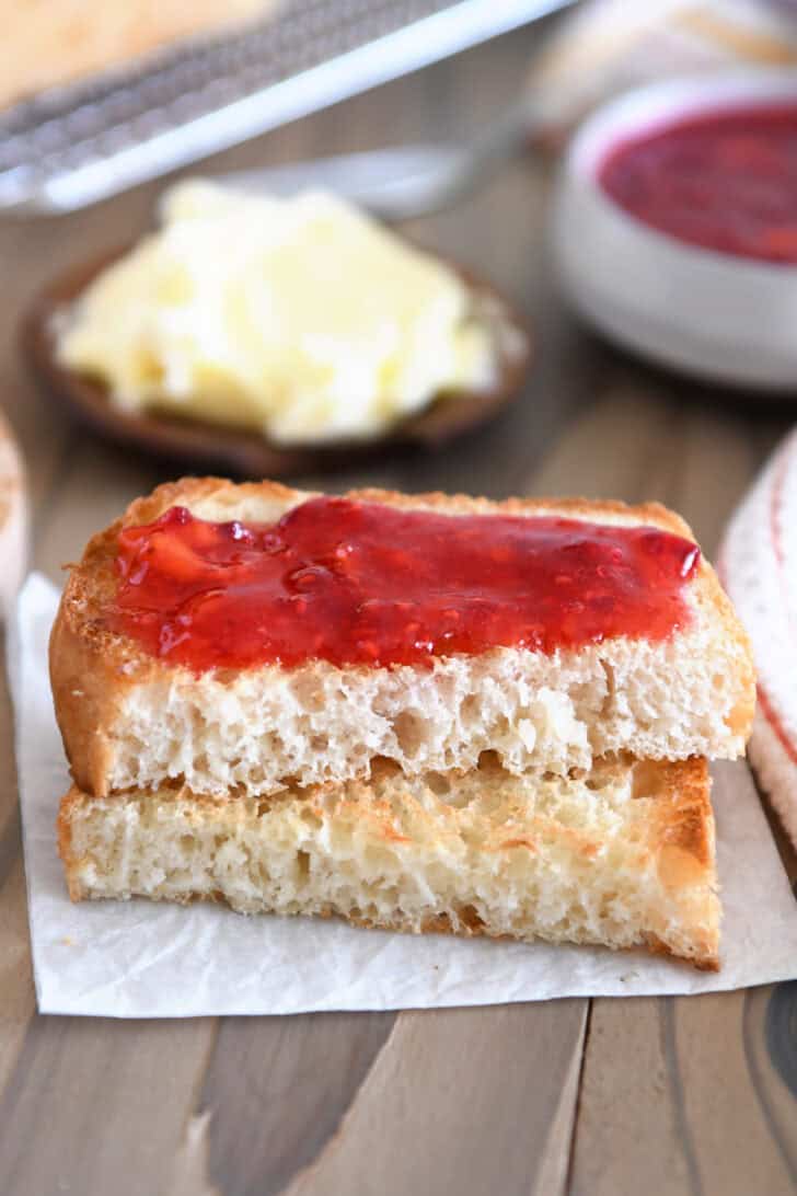 Half slice toasted bread with raspberry jam.