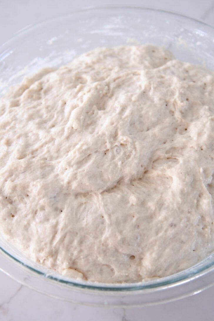 Lumpy dough mixed in glass bowl.
