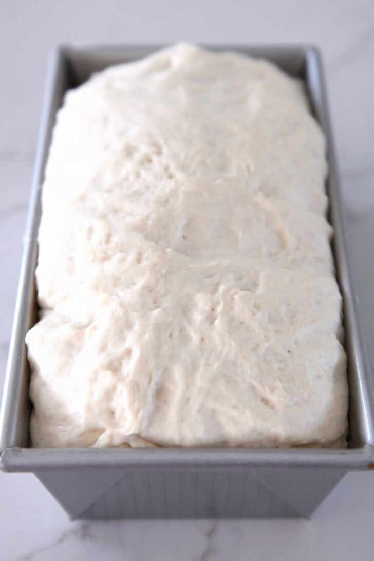Unbaked risen dough in bread pan.