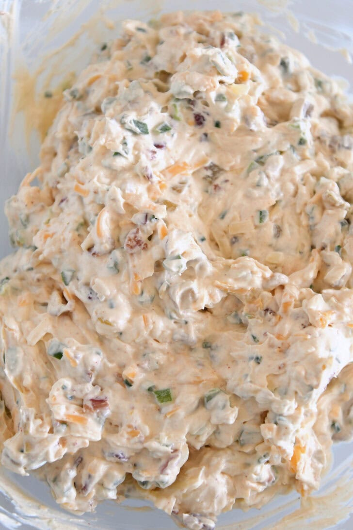 Glass bowl with creamy cheesy bacon jalapeno dip.