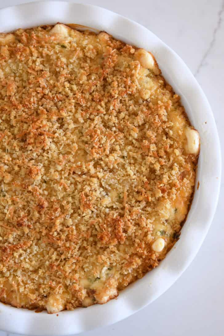 Top down view of baked bacon jalapeno popper dip in white plate.