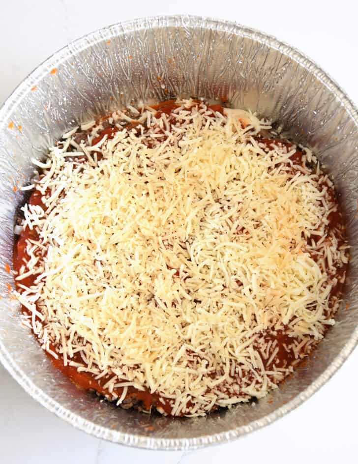 Top down view of shredded cheese in Dutch oven liner.