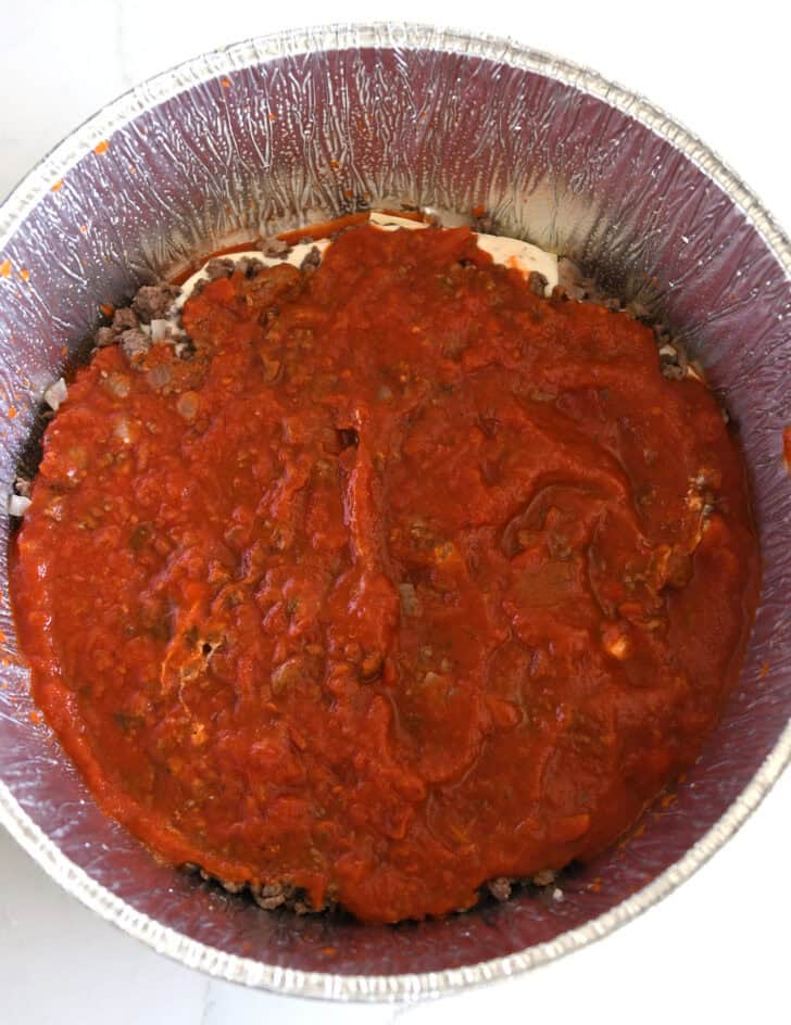 Top down view of pasta sauce in Dutch oven liner.