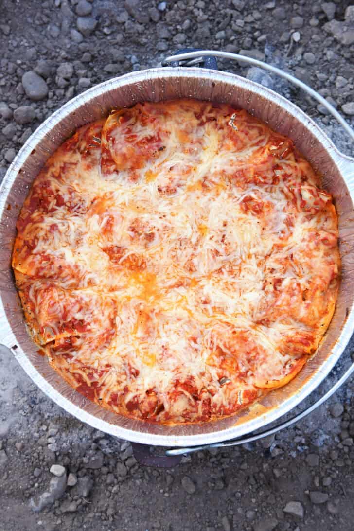 Top down view of cooked lasagna in Dutch oven with liner.